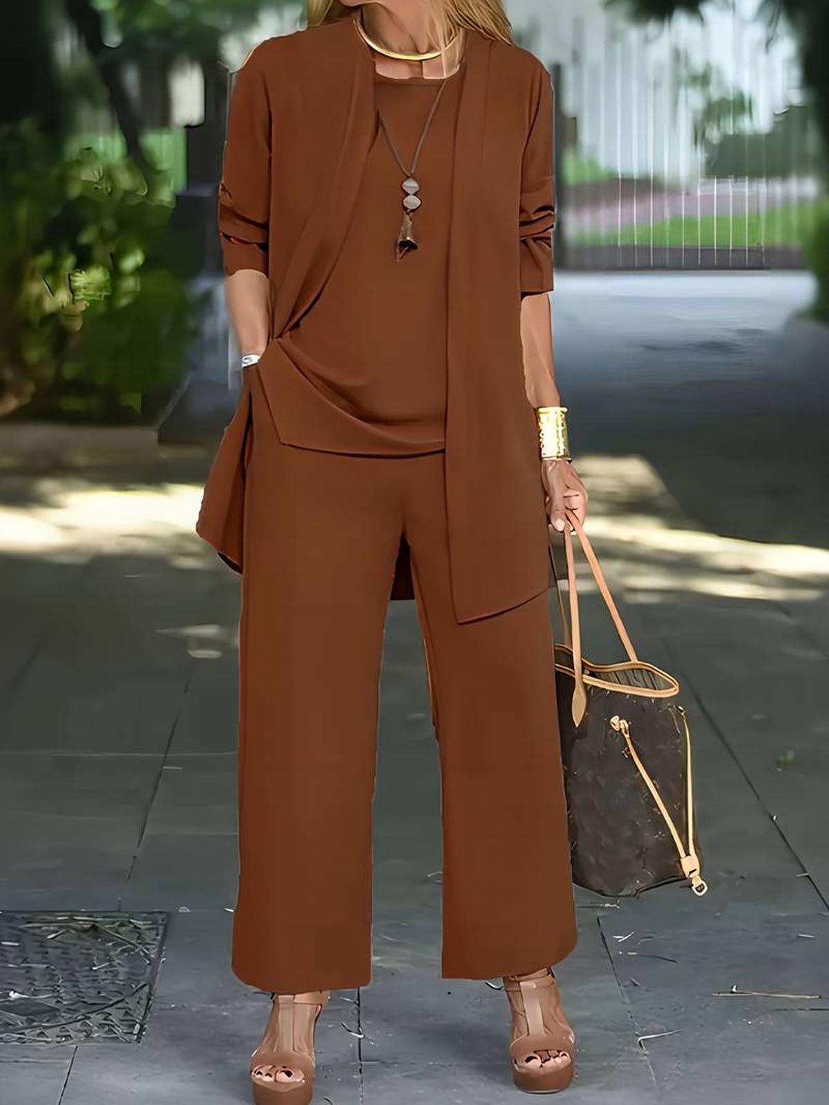 Women's three-piece relaxed outfit set in neutral tones with wide-leg pants and lightweight layered top