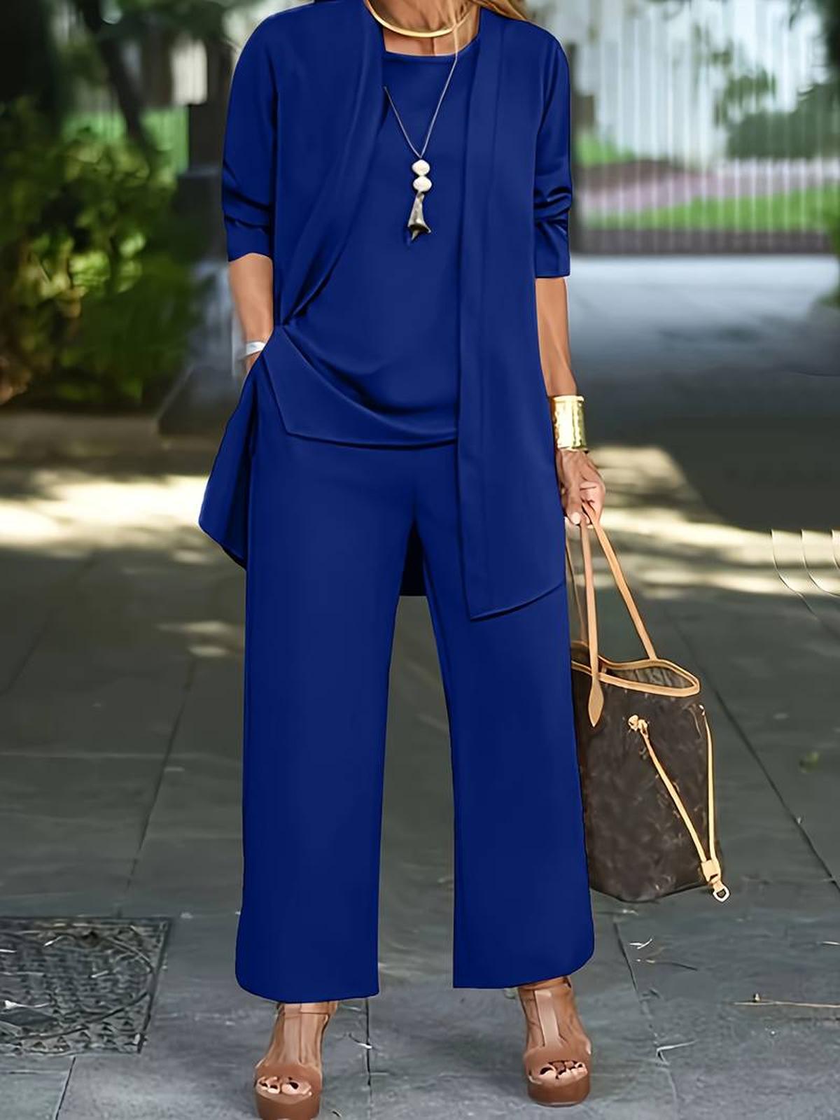 Women's three-piece relaxed outfit set with flowing top, wide-leg pants, and lightweight outer layer