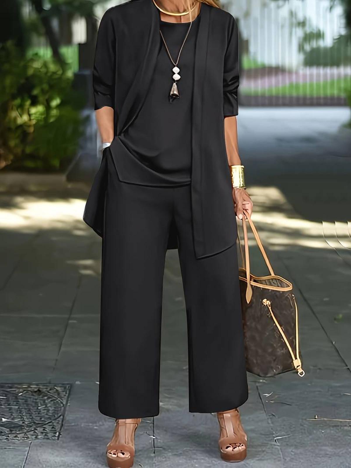 Women's three-piece relaxed outfit set with flowing top, wide-leg pants, and lightweight outer layer