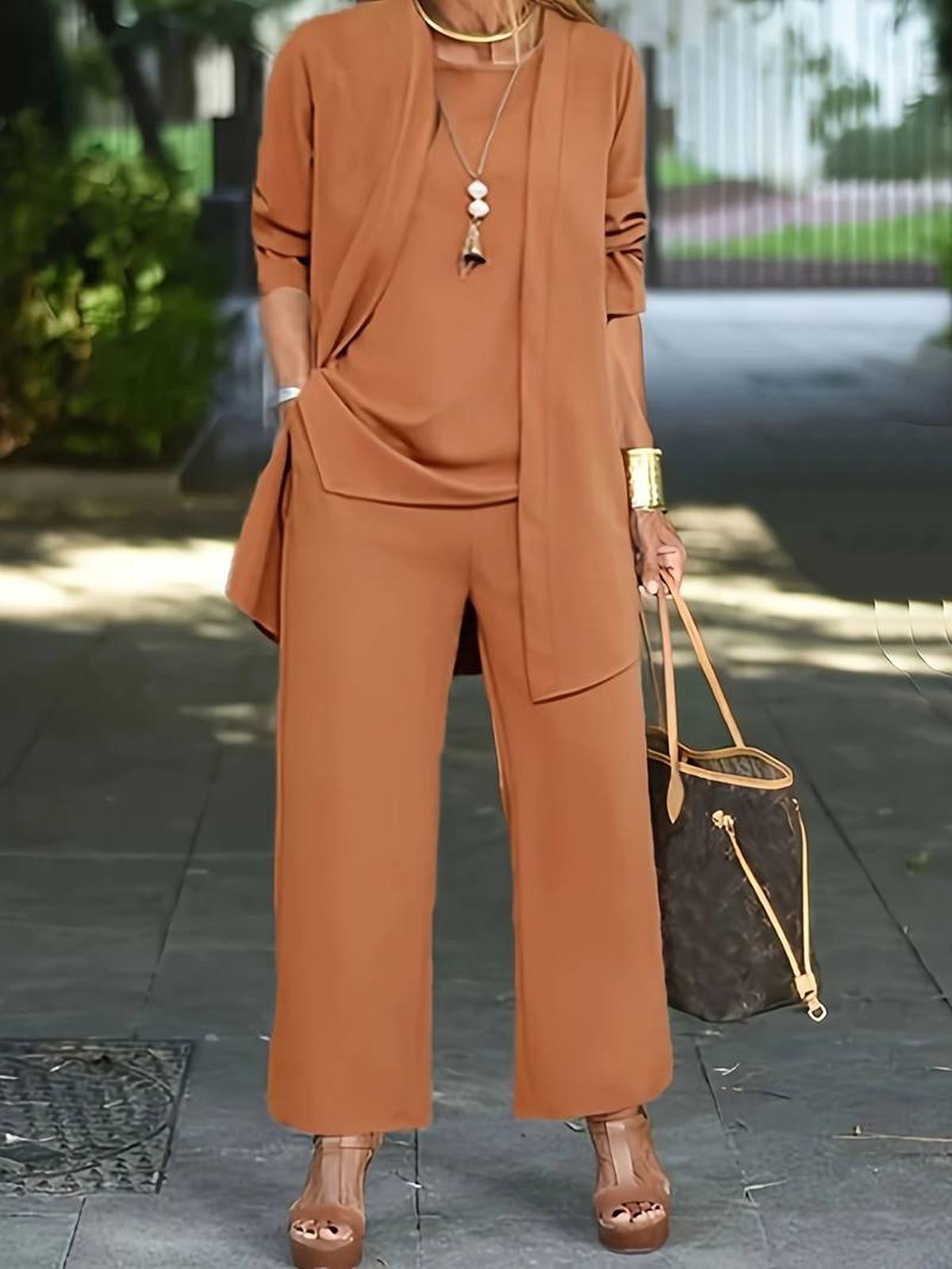 Women's three-piece relaxed outfit set with wide-leg pants, flowing top, and lightweight layer