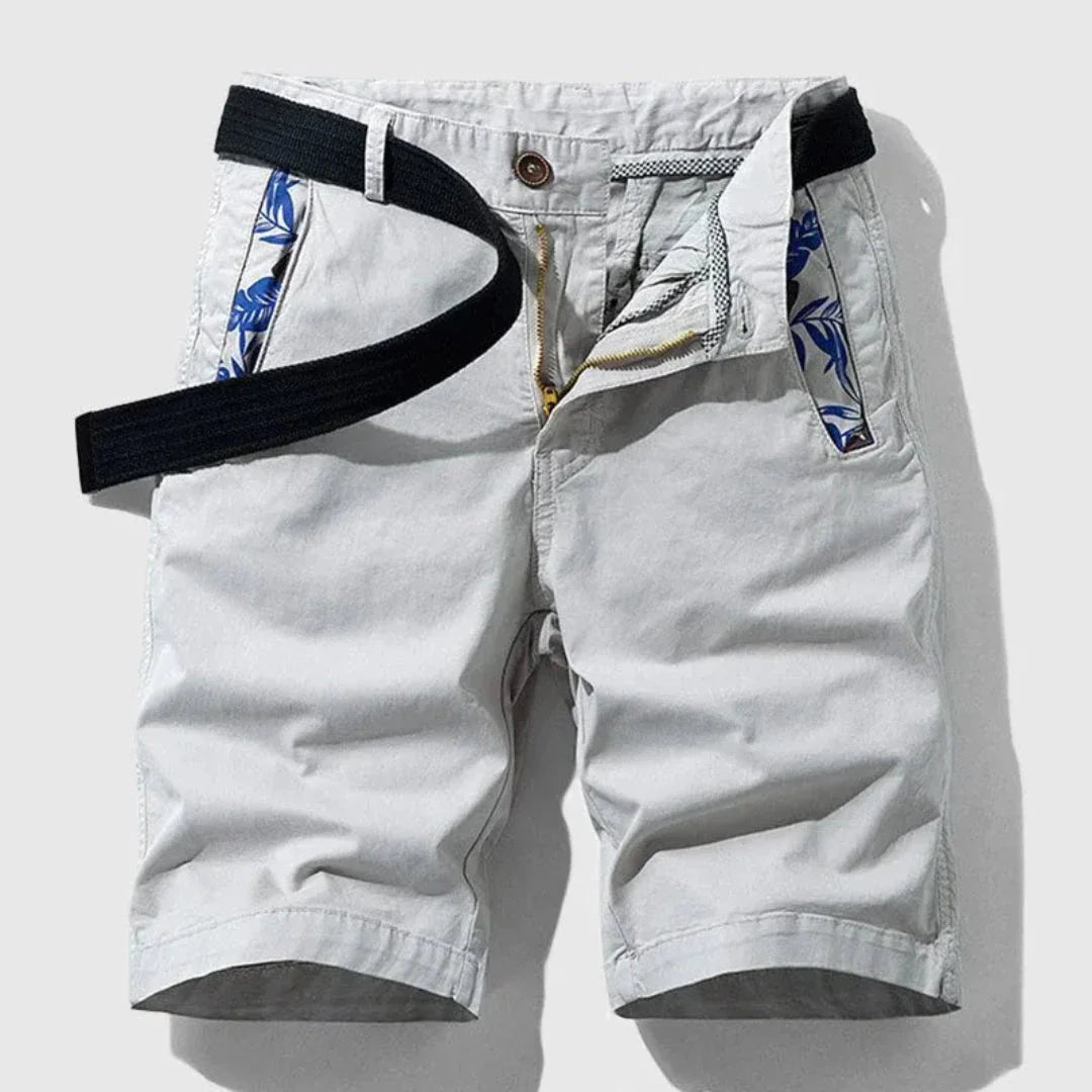Men's navy cotton stretch shorts with zipper fly, belted waist, and floral pocket lining detail