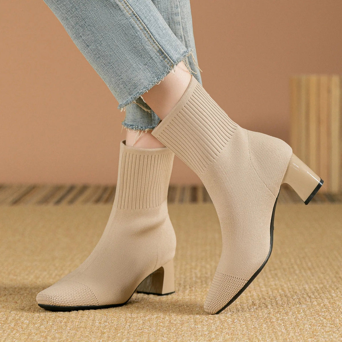 Women's black knitted sock ankle boots with 2.5-inch heel, stretchy fabric and sleek contemporary silhouette