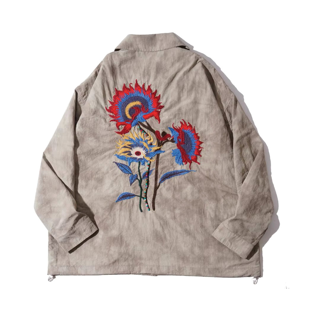 Beige floral embroidered shirt jacket with button closure, drawstring hem, and retro long-sleeve design