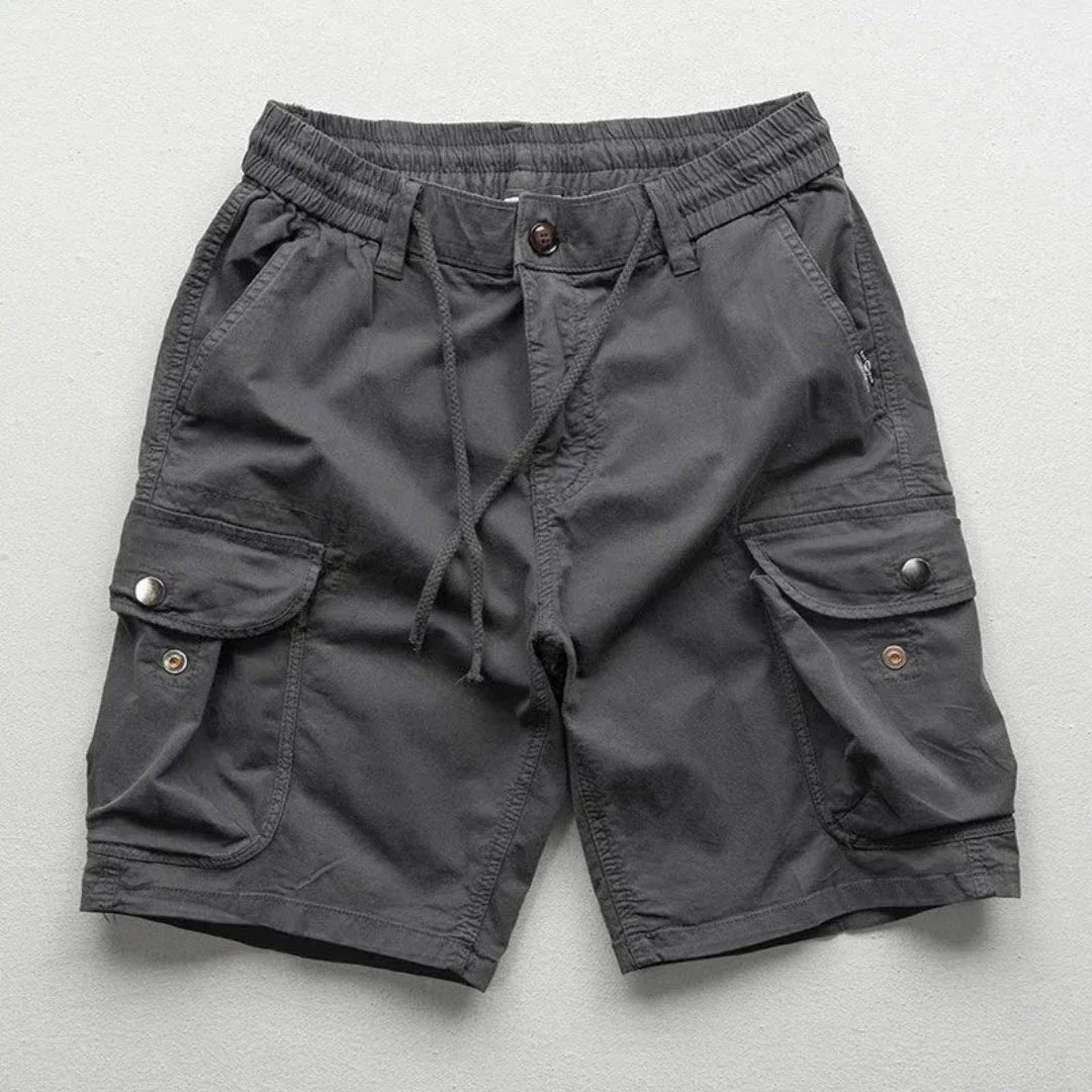 Men's khaki relaxed-fit cargo shorts with elastic waist, multi-pocket design for hiking and travel