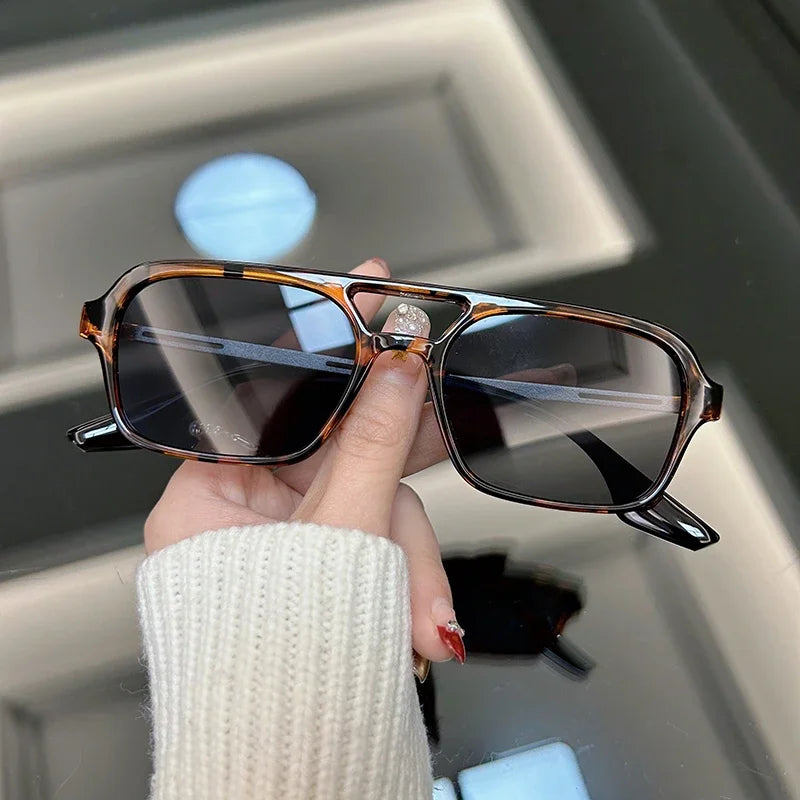 Bold black rectangular acetate sunglasses with angular retro-modern frames for everyday style