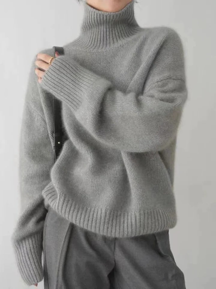 Women's ivory turtleneck sweater with smooth sleek knit, slim silhouette, and high cozy neckline