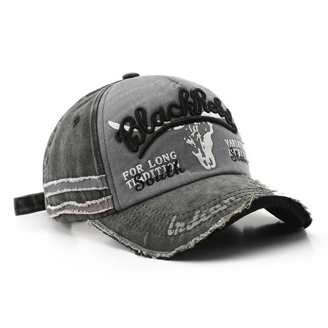 Black cotton trucker hat with embroidered Rebel lettering, distressed detailing, and adjustable snapback closure