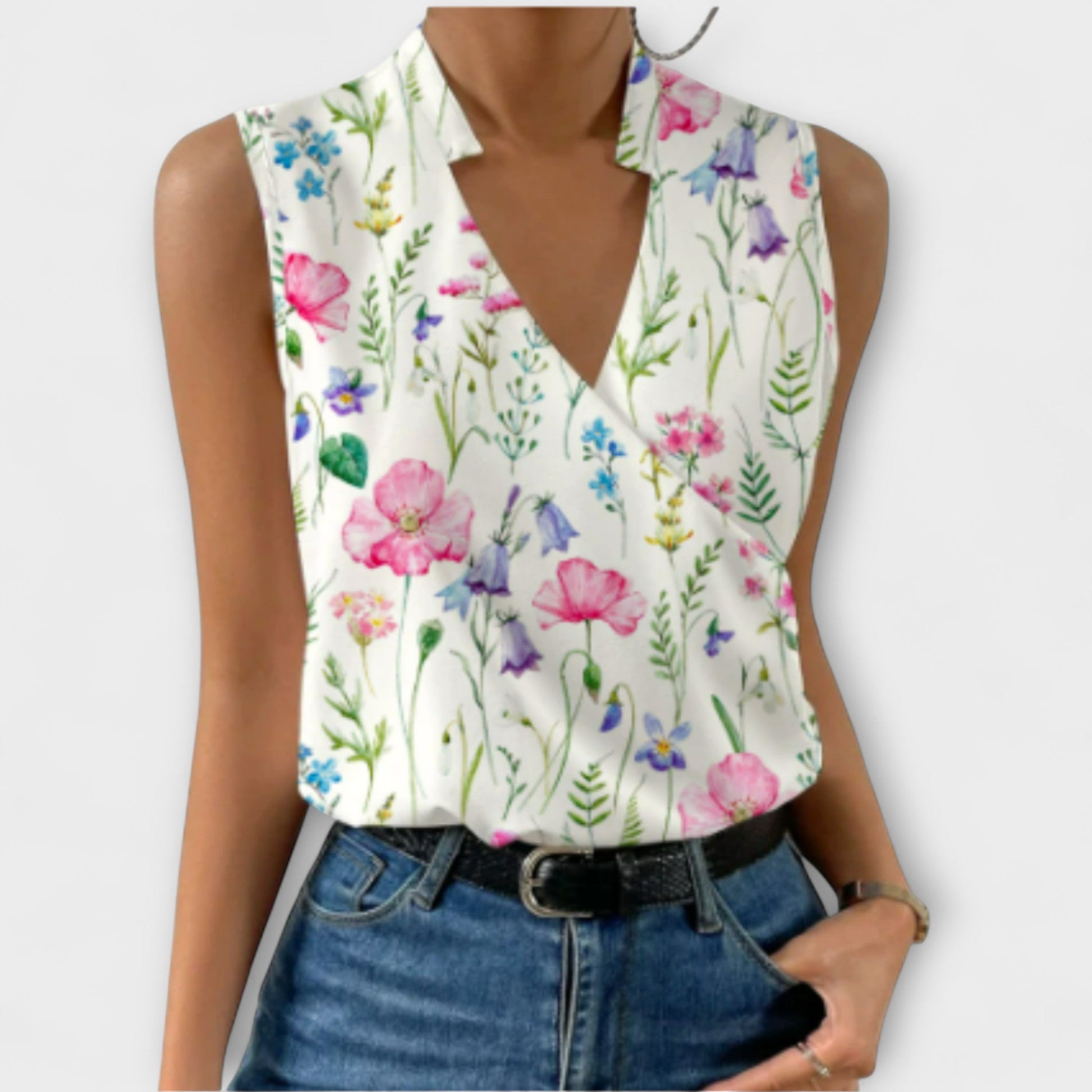 Women's sleeveless white wrap collar blouse with crossover V-neckline drape, effortlessly chic style