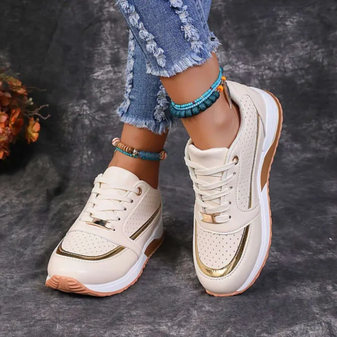 Women's white faux leather low-top platform sneakers with lace-up closure and perforated panels