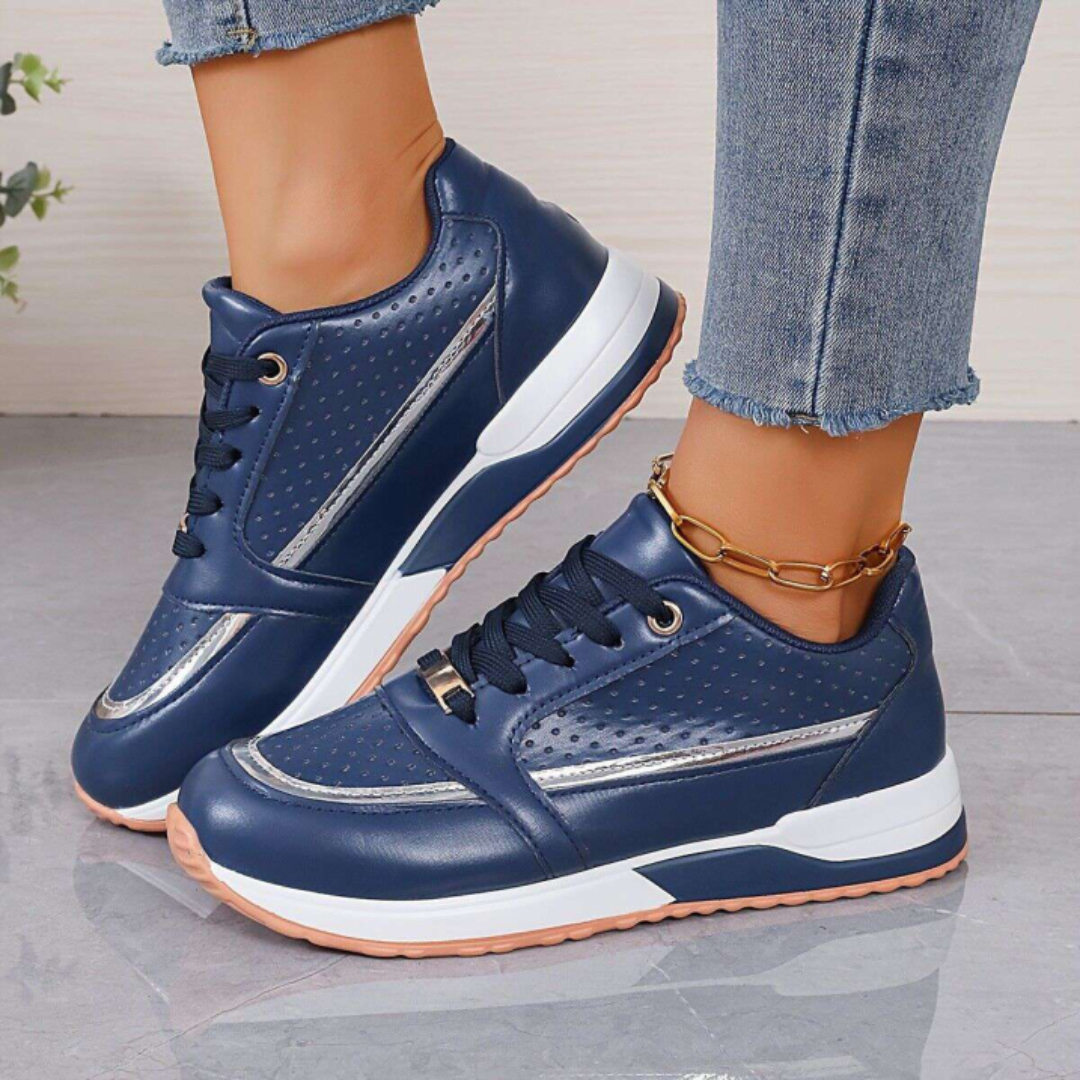 Women's white faux leather low-top platform sneakers with lace-up closure and perforated panels