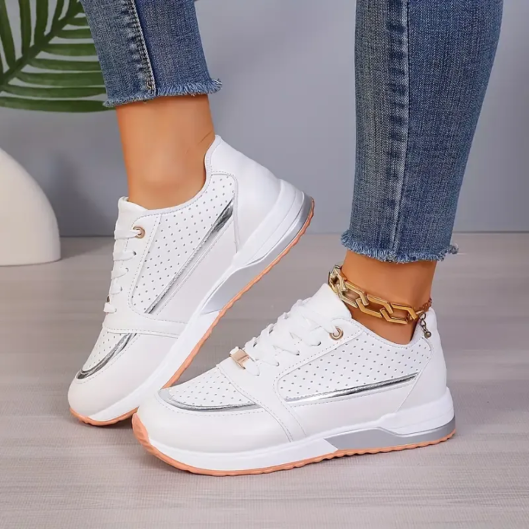 Women's white faux leather low-top platform sneakers with lace-up closure and perforated panels