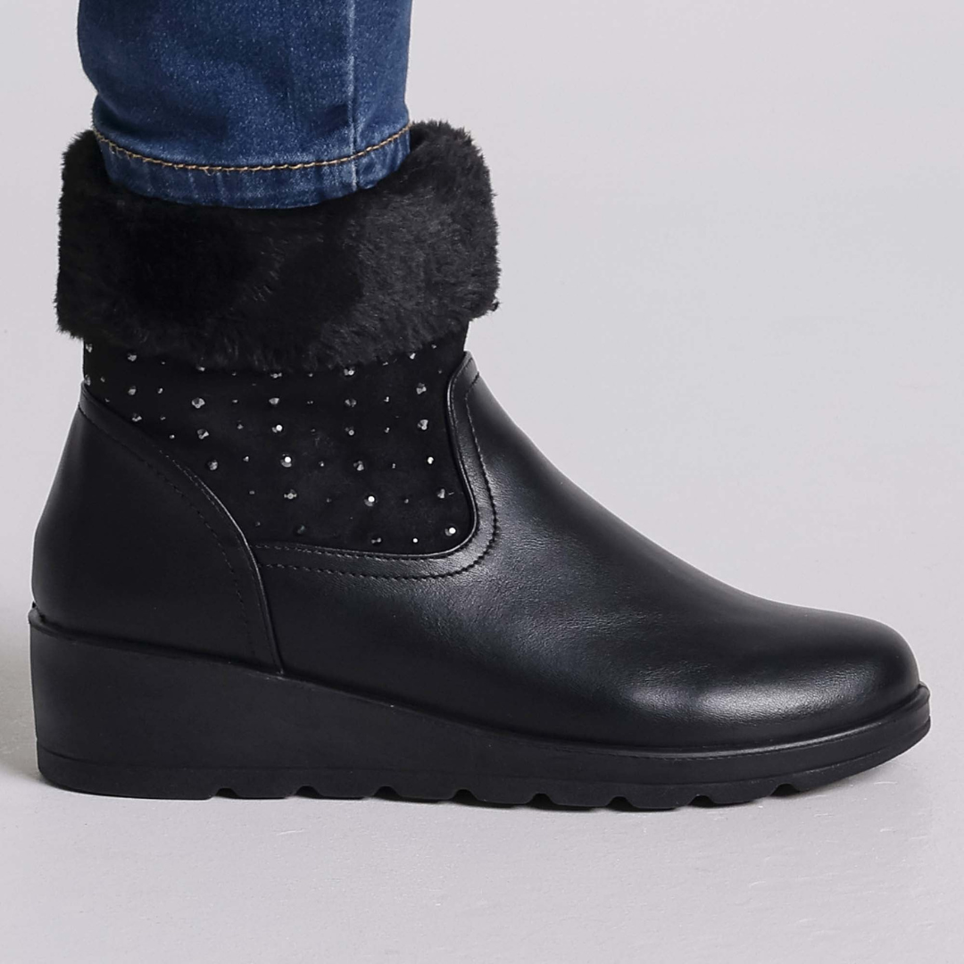Ammy ankle boots with plush faux-fur lining, stud accents, and side zipper in elegant winter style