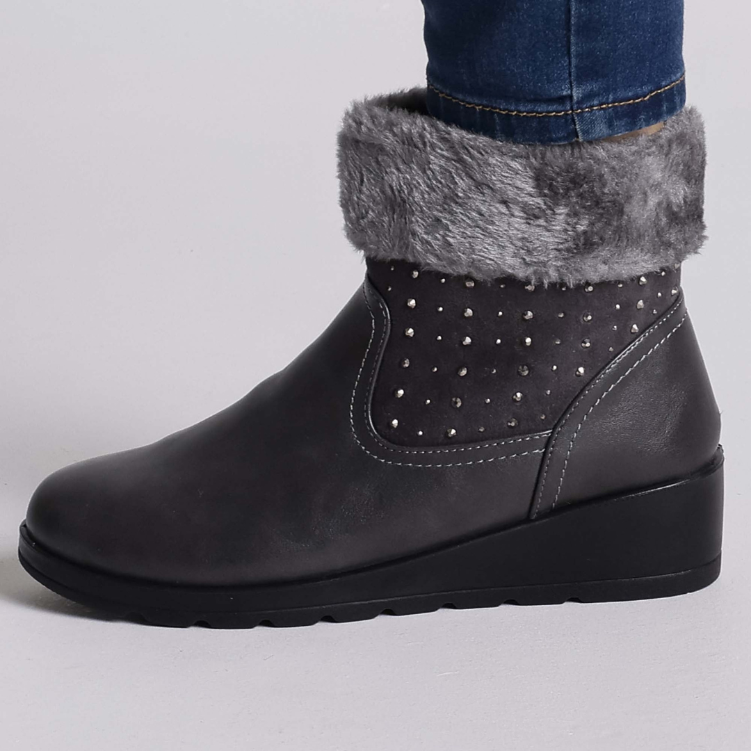 Ammy ankle boots with plush faux-fur lining, stud accents, and side zipper in elegant winter style