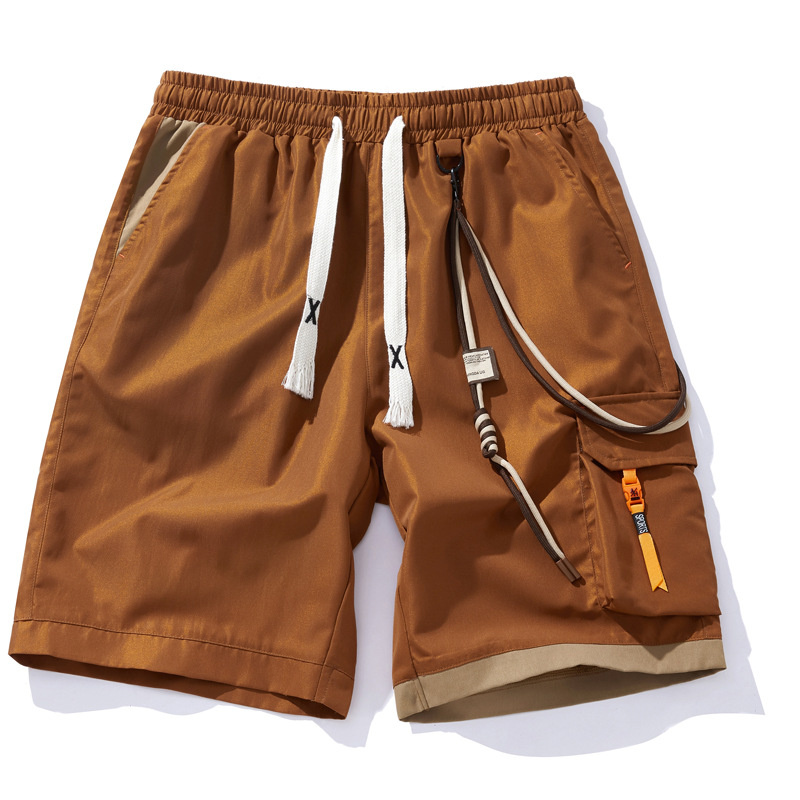 Black street shorts with contrast orange accents, cargo pockets and elastic drawcord waist
