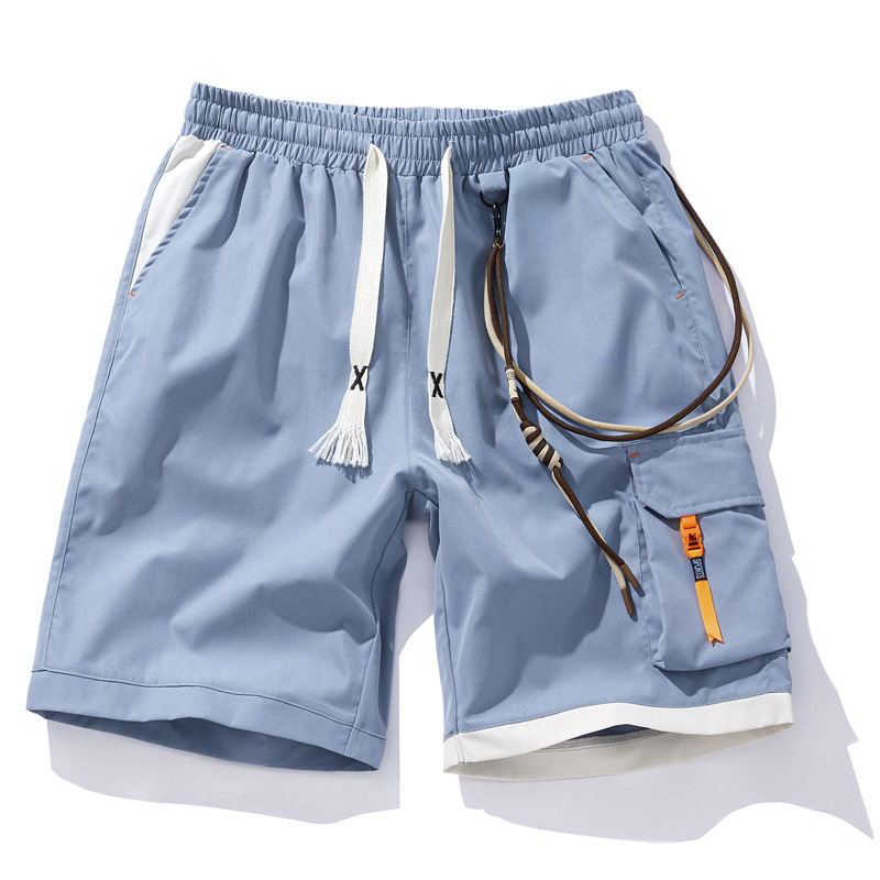 Black street shorts with contrast orange accents, cargo pocket, elastic waist, and utility strap details
