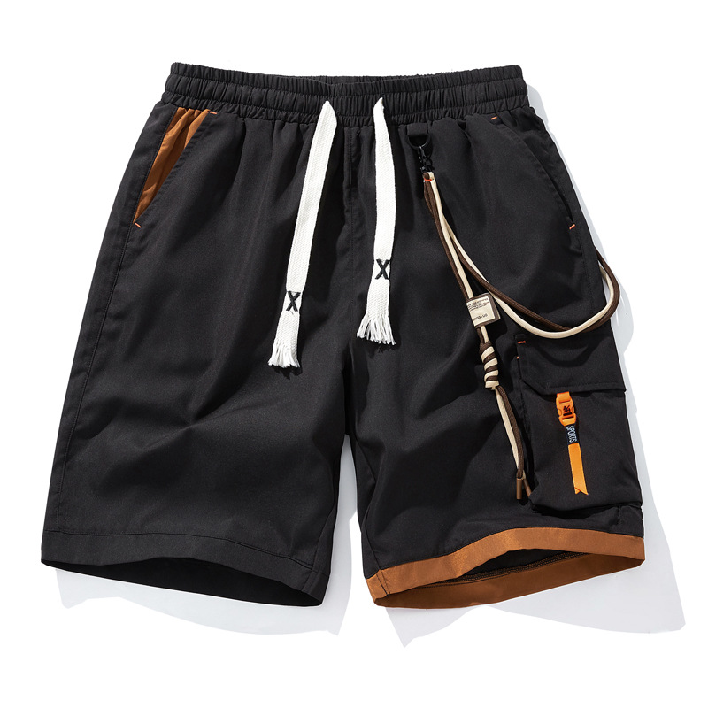 Black street shorts with contrast orange accents, cargo pocket, elastic waist, and urban utility design