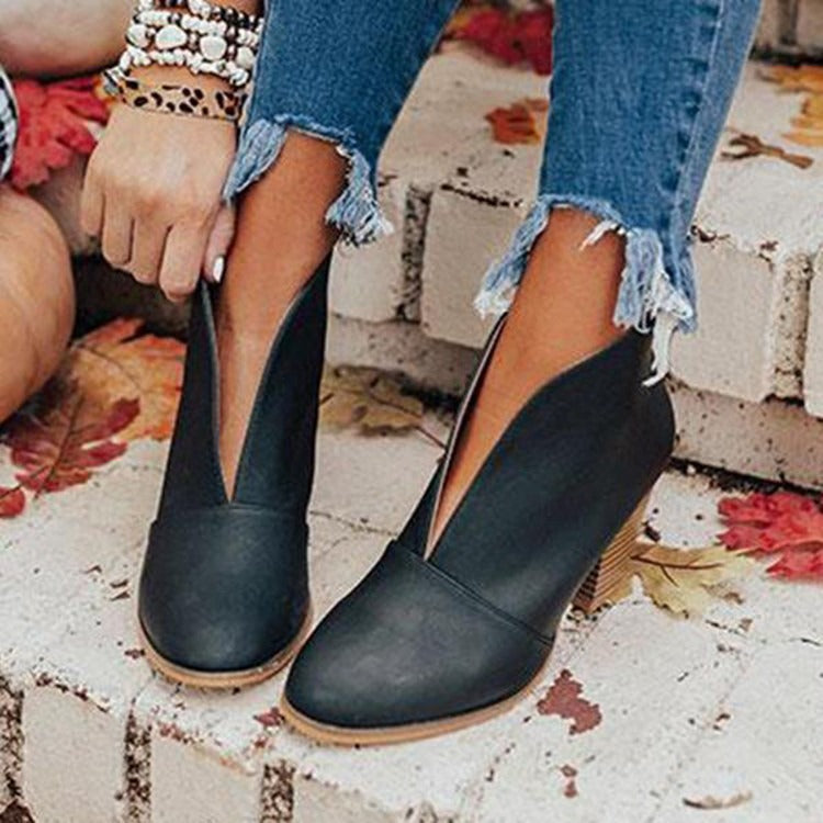 Women's black slip-on ankle boots with V-cut side cutout and 3-inch stacked heel