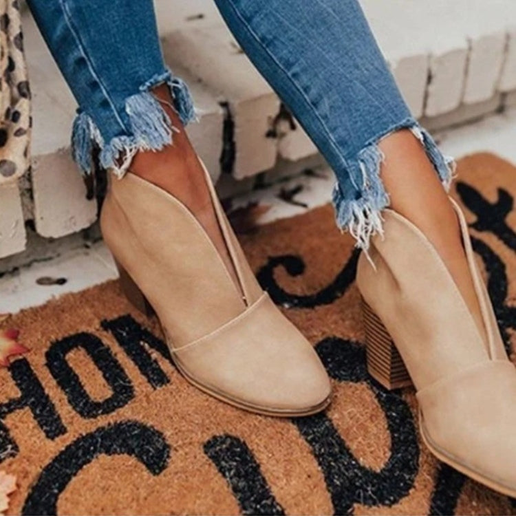Women's black slip-on ankle boots with V-cut side cutout and stacked heel for a sleek silhouette