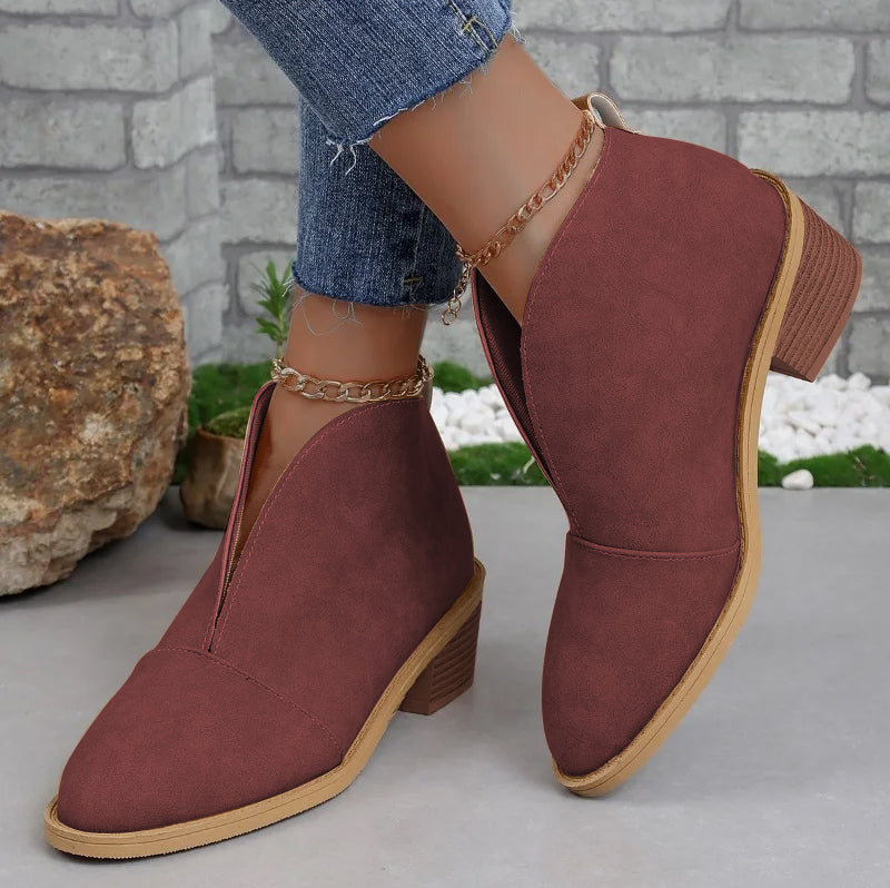 Women's black slip-on ankle boots with V-cut side cutout and stacked heel for elongating silhouette
