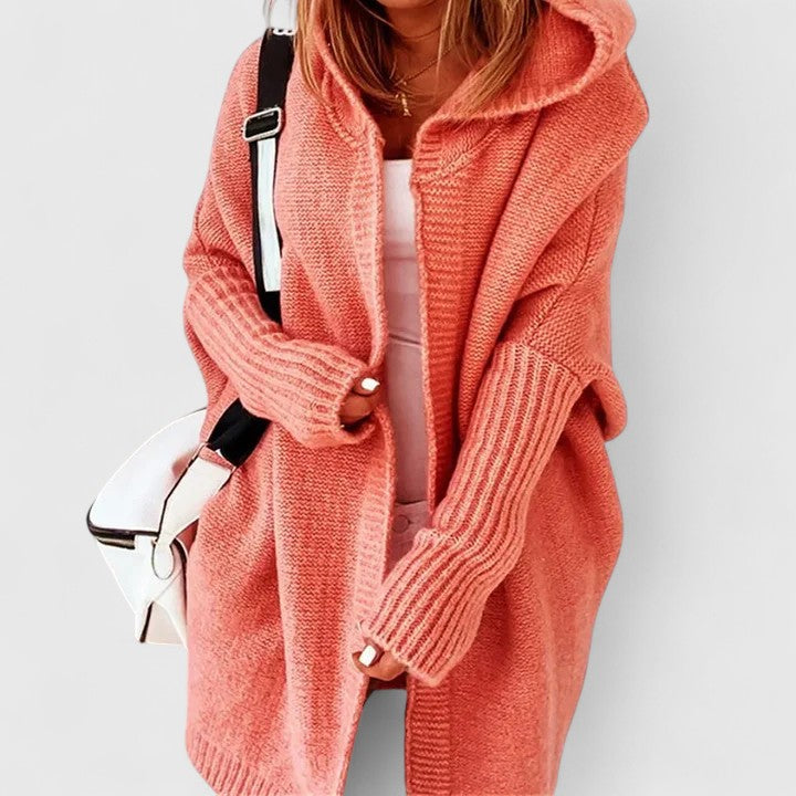 Oversized hooded knit cardigan in neutral tone with relaxed fit and knee-length silhouette