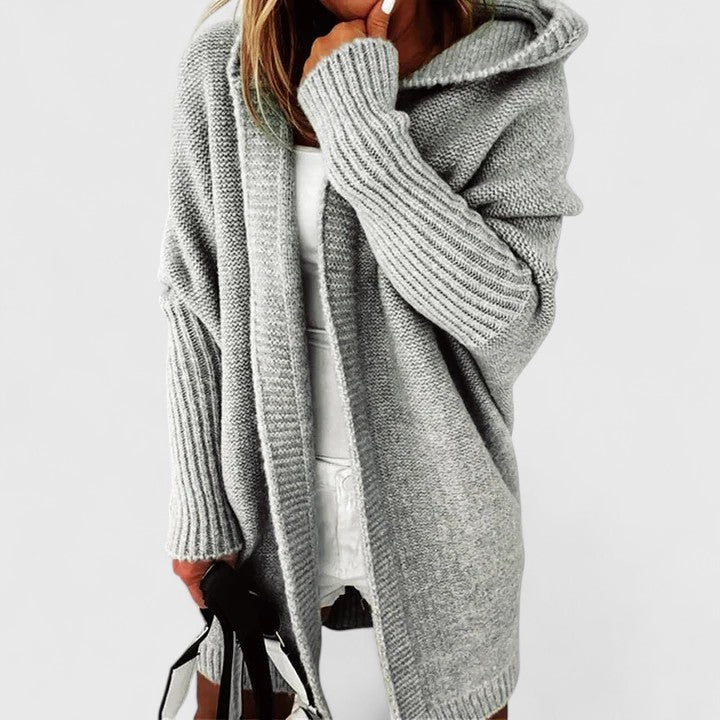 Oversized hooded knit cardigan in neutral tone, knee-length relaxed fit with cozy layering style