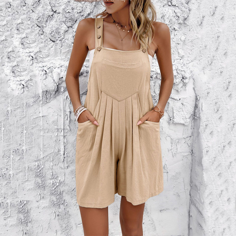 Women's fluid draped short jumpsuit with adjustable buttoned straps, soft pleats, and side pockets