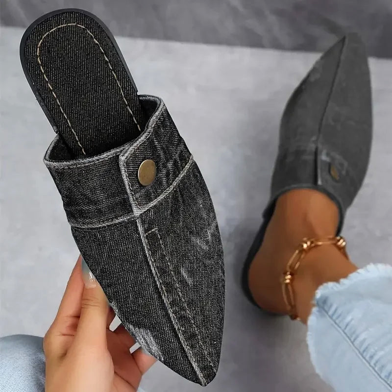 Light-wash denim pointed-toe mule flats with open-back design and gold stud accent