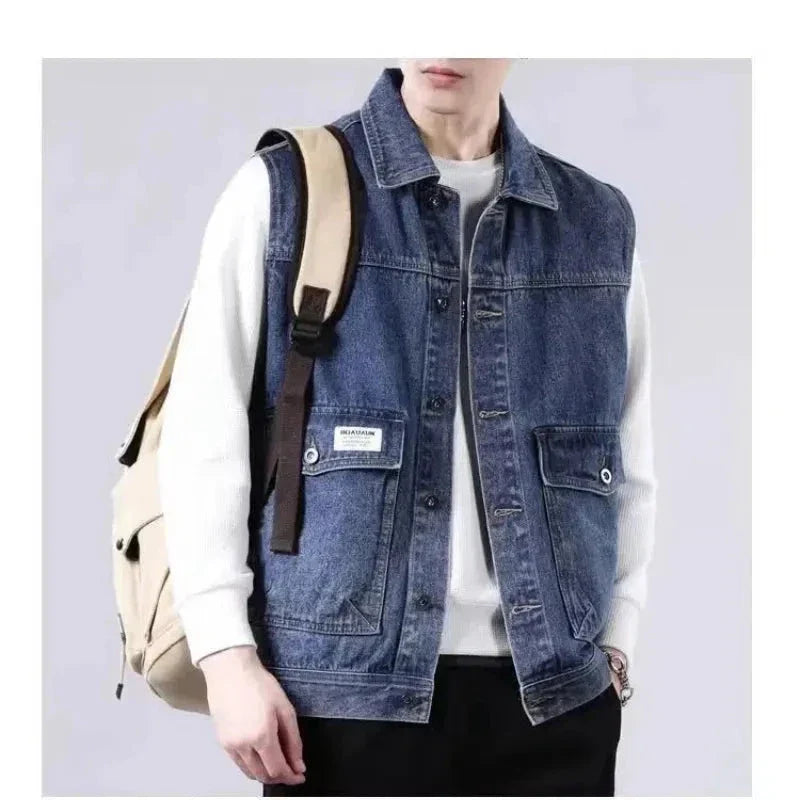 Classic blue denim vest with button-up closure, rugged washed finish, and sleeveless layering design