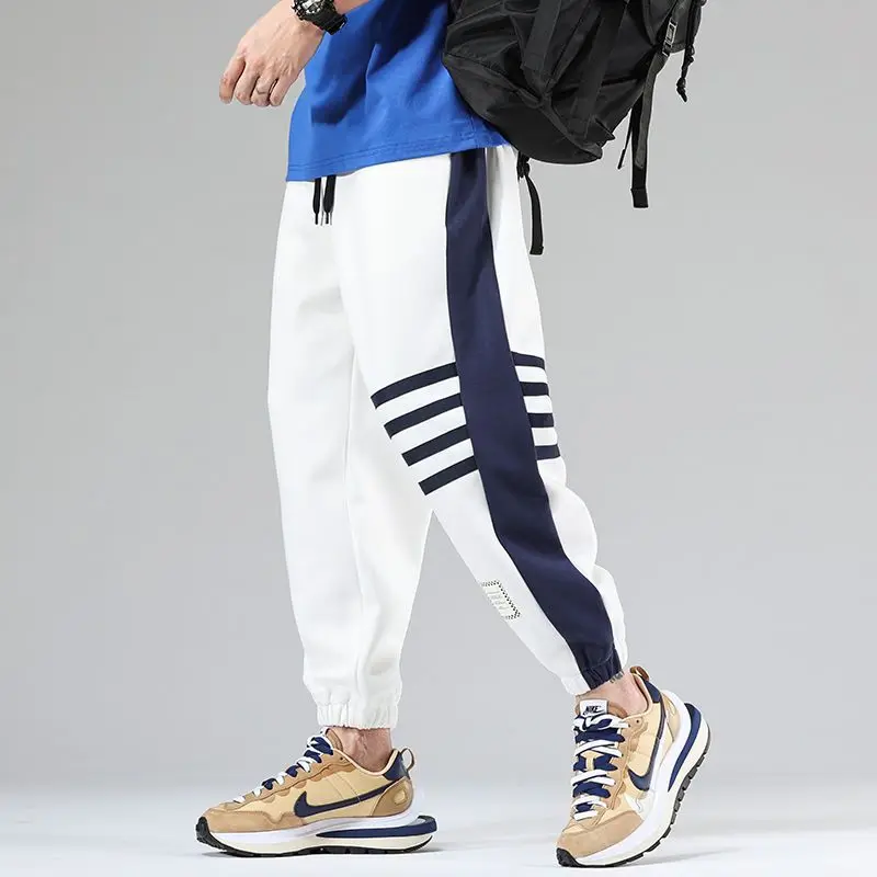 Black and white premium varsity joggers with bold contrast color block paneling and stripe detailing