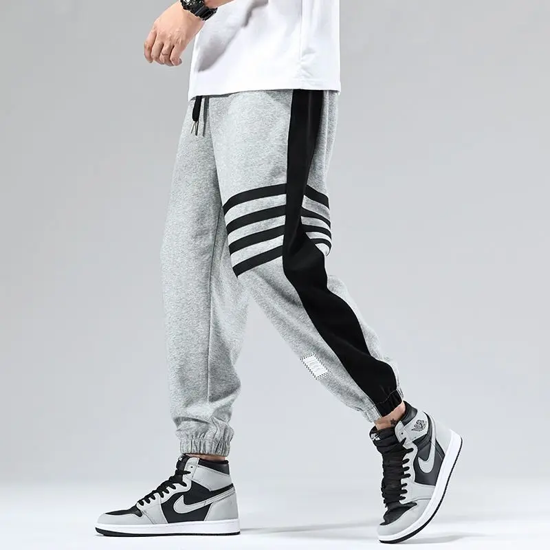 Black and white color block varsity joggers with contrast side stripes and elastic cuffs