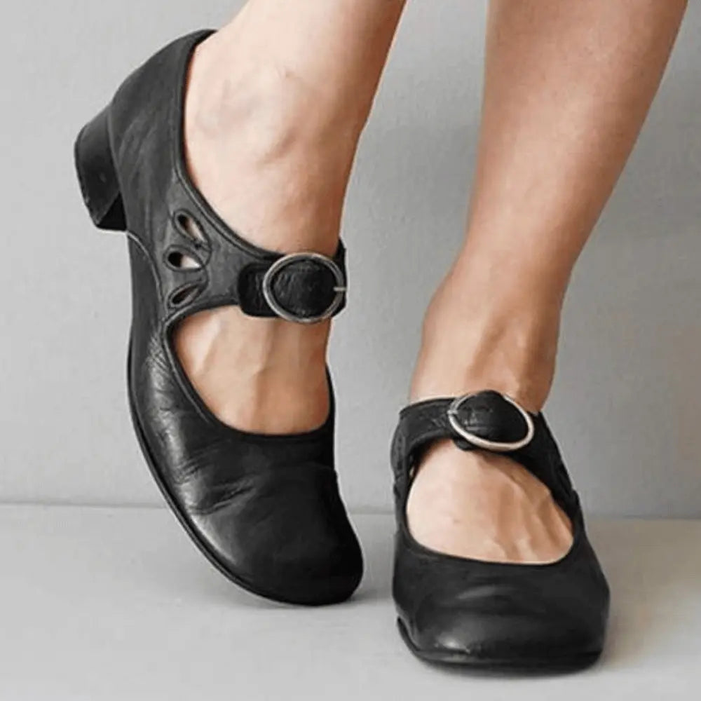Women's vintage Mary Jane flats in classic faux leather with delicate cutout detailing for elegant style