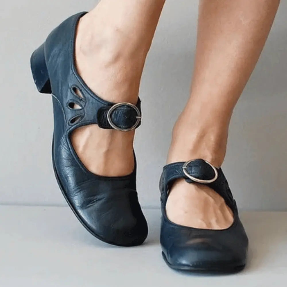 Women's vintage-style Mary Jane flats in smooth faux leather with delicate cutout detailing