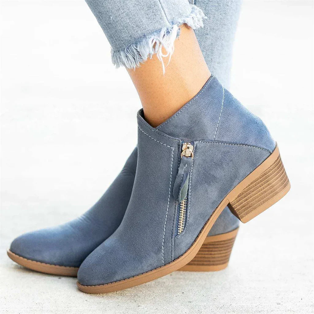Women's black zip heel boots with sleek side closure and wood-toned stacked heel for day-to-night style