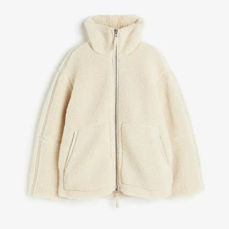 Women's sherpa fleece jacket in soft neutral tone, relaxed fit with high collar and front zipper