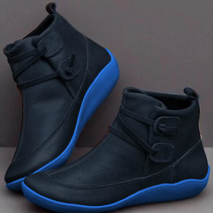 Black waterproof vegan leather ankle boots with cushioned interior, sleek silhouette for all-day wear