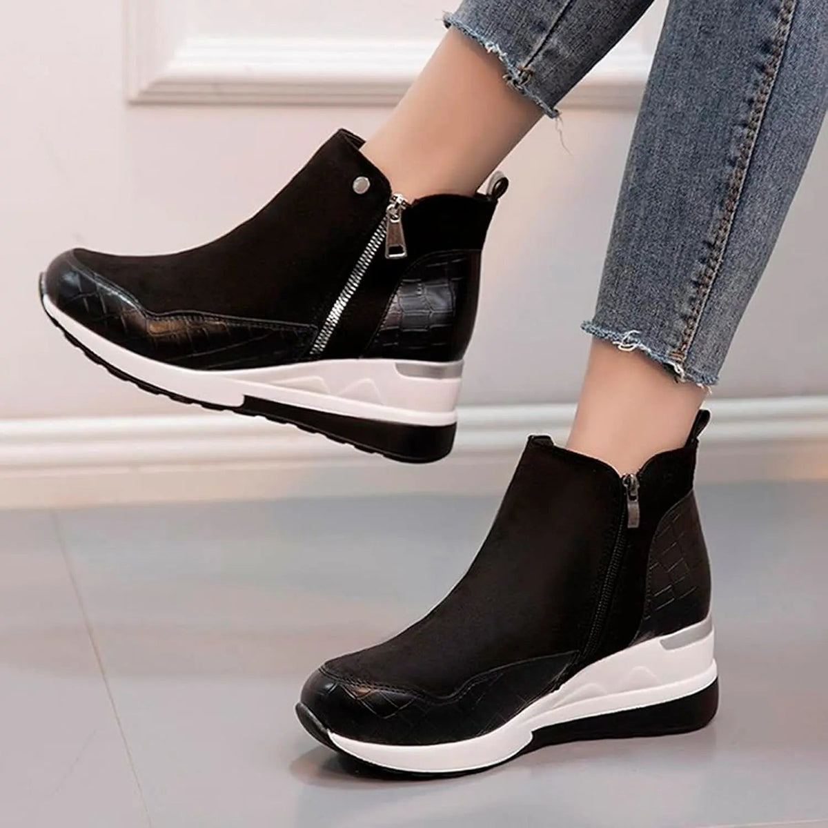 Women's black wedge heel winter boots with cushioned insole and sleek ankle silhouette