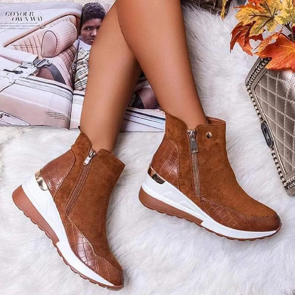 Women's brown wedge heel winter boots with cushioned insole and sleek ankle-high silhouette