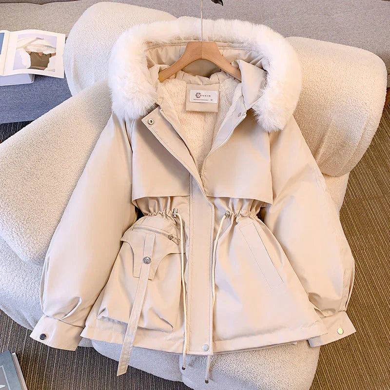 Women's olive green winter parka jacket with fur trim hood and adjustable waist for a flattering fit