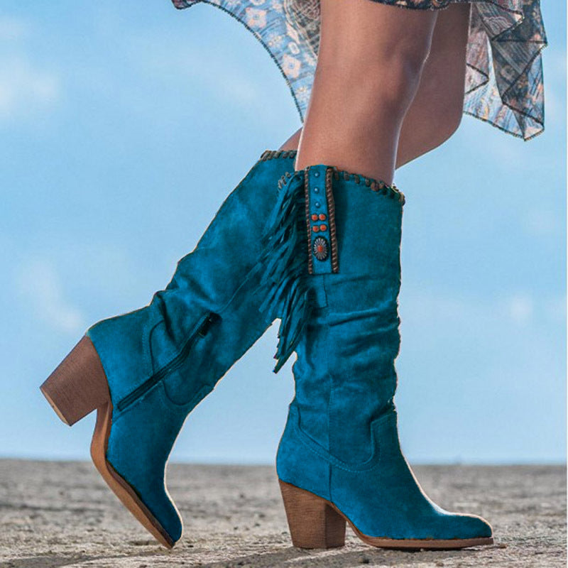 Suede knee-high Western boots with fringe tassels, turquoise accents, and braided trim in rustic chic style