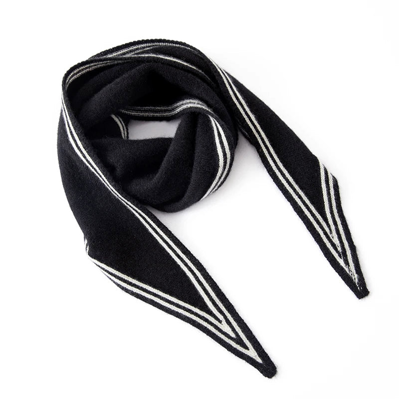 Women's cashmere knit scarf in beige with black contrast stripe trim, slim elongated silhouette