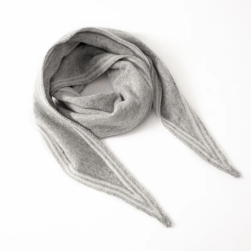 Women's slim cashmere knit scarf in neutral tones with contrast stripe trim, elegant winter wrap