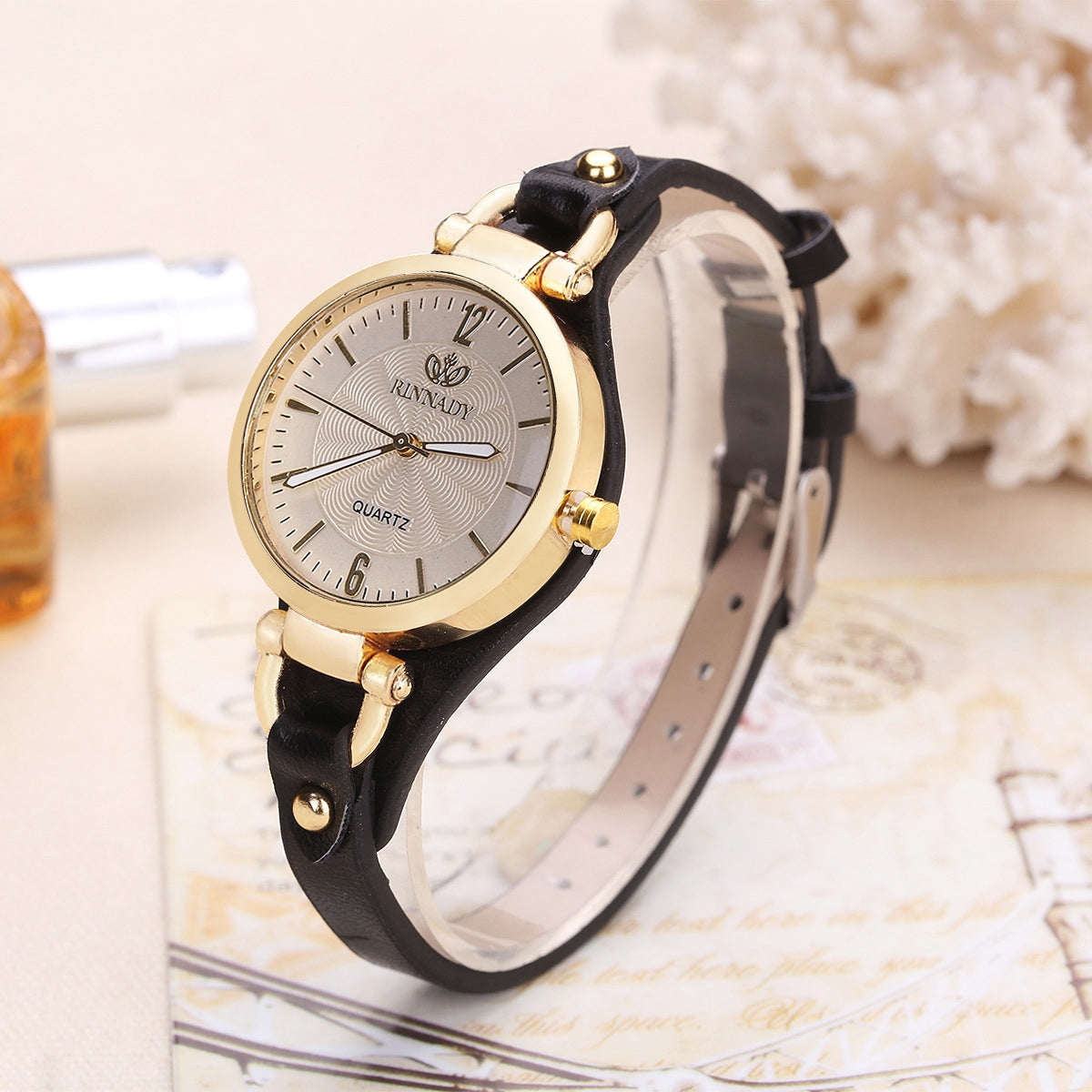 Women's quartz wristwatch gold-tone bezel slim faux leather strap minimalist dial metallic accents