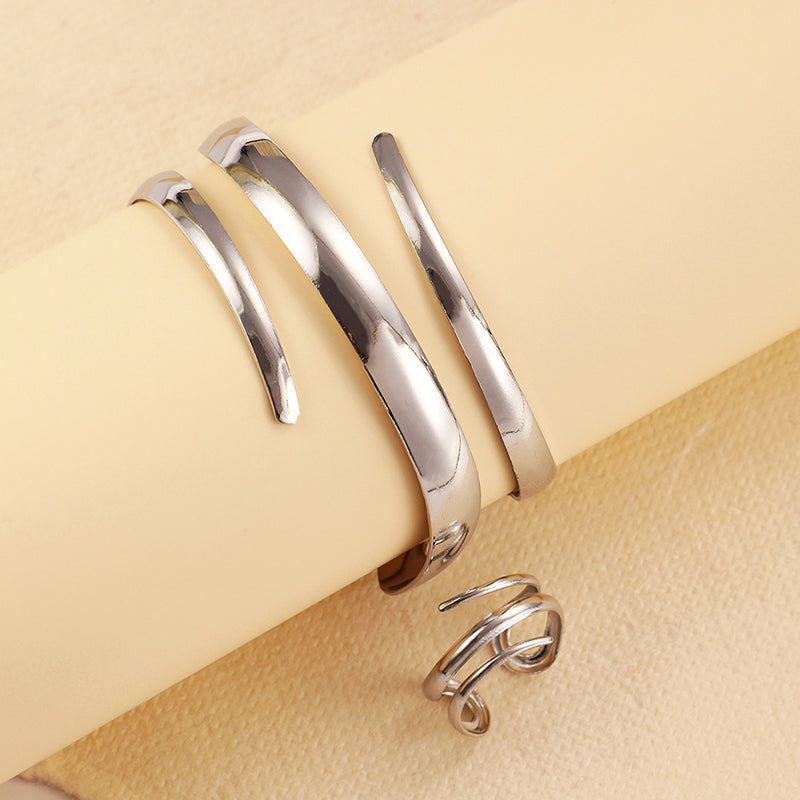 Gold tone sculptural spiral wrap bracelet and ring set with open-curve design for women