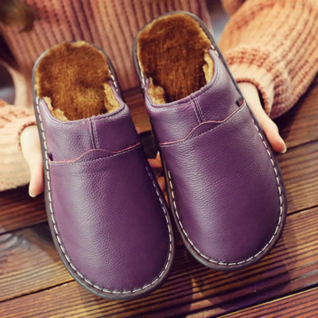Women's faux leather slip-on sandals with plush fur lining, sleek silhouette, cozy indoor style