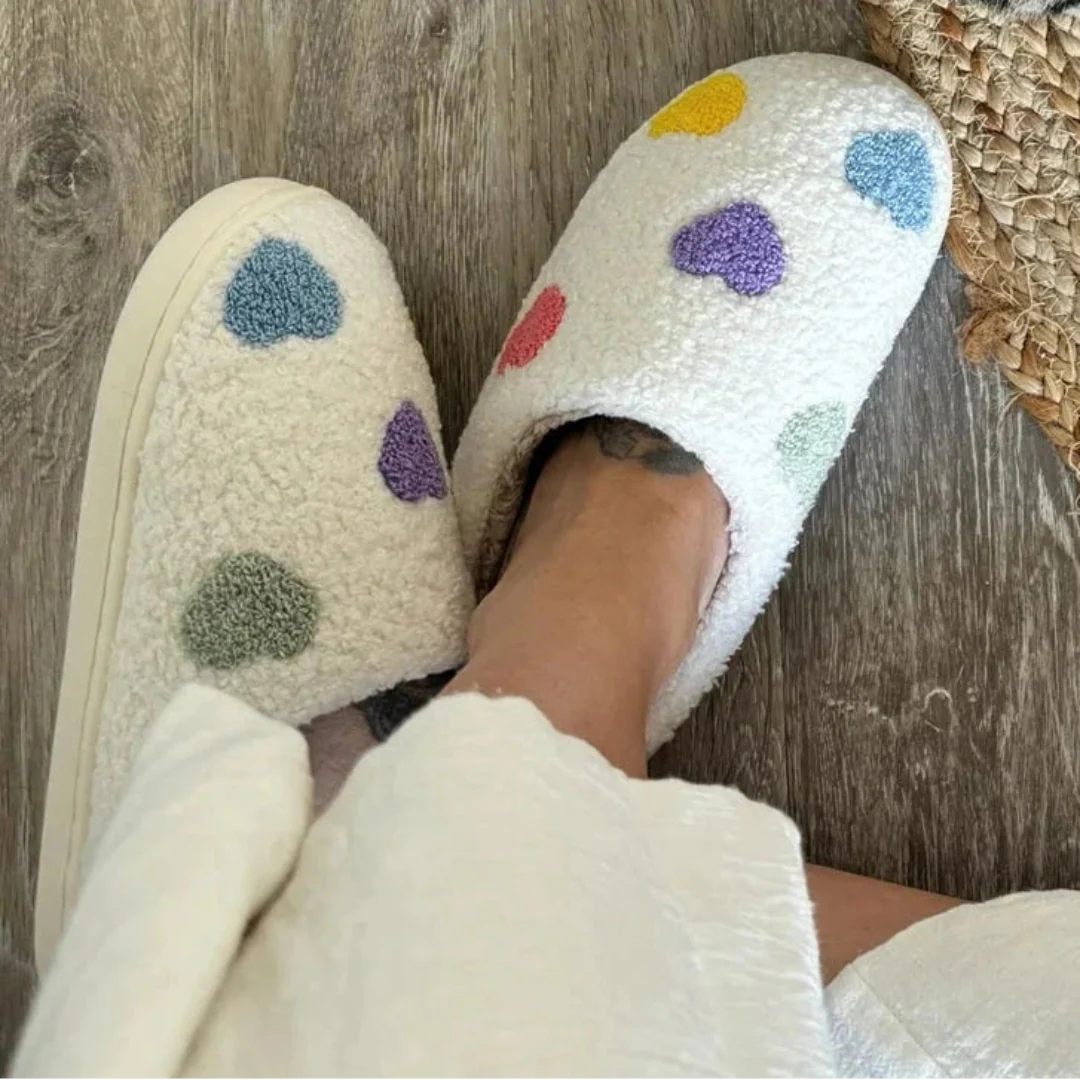Women's white sherpa plush slippers with colorful embroidered pastel hearts and non-slip sole