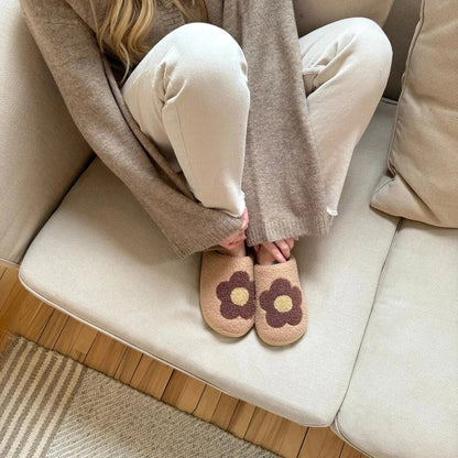 Women's pink plush fleece slip-on slippers with embroidered flower detail and cushioned insole