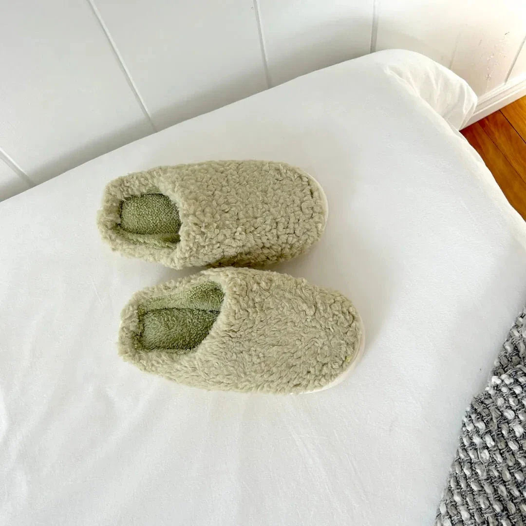 Women's plush slip-on house slippers in soft teddy-texture fleece with cushioned insole for cozy comfort