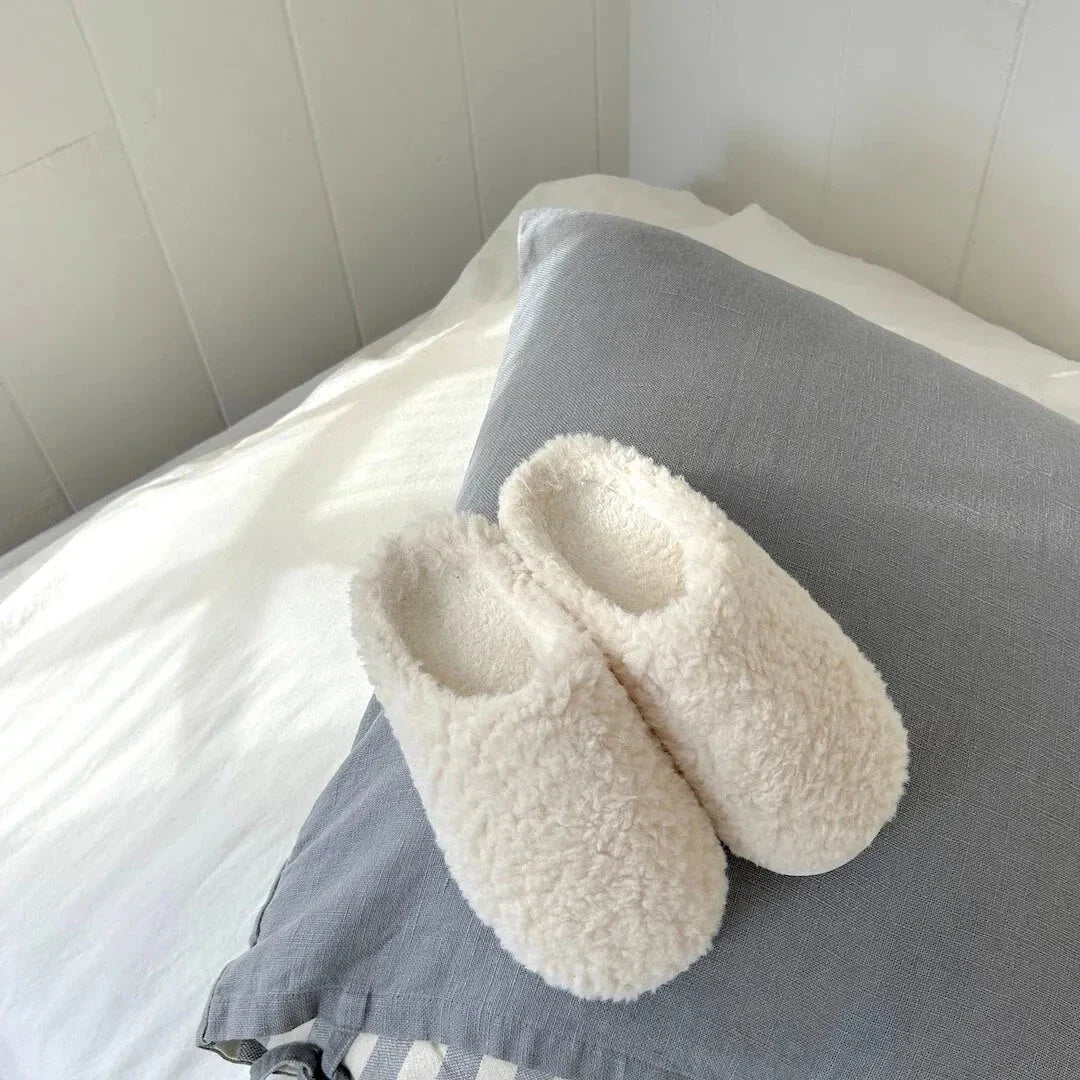 Women's plush slip-on house slippers in fluffy teddy-texture fleece with cushioned insole