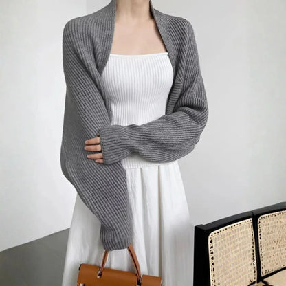 Women's soft ribbed shrug cardigan in neutral tone, open-front draped silhouette with relaxed long sleeves