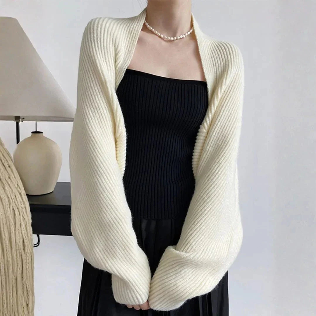 Women's soft ribbed shrug cardigan in neutral tone, open-front draped silhouette with relaxed long sleeves